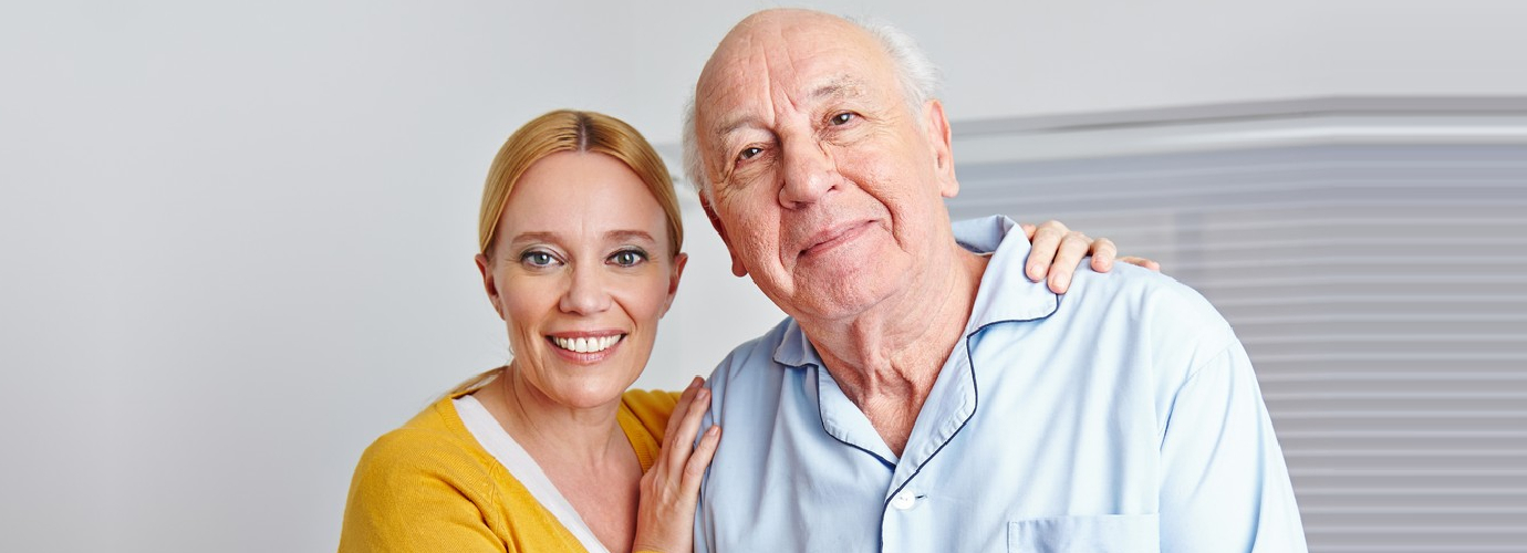 senior man and caregiver smiling